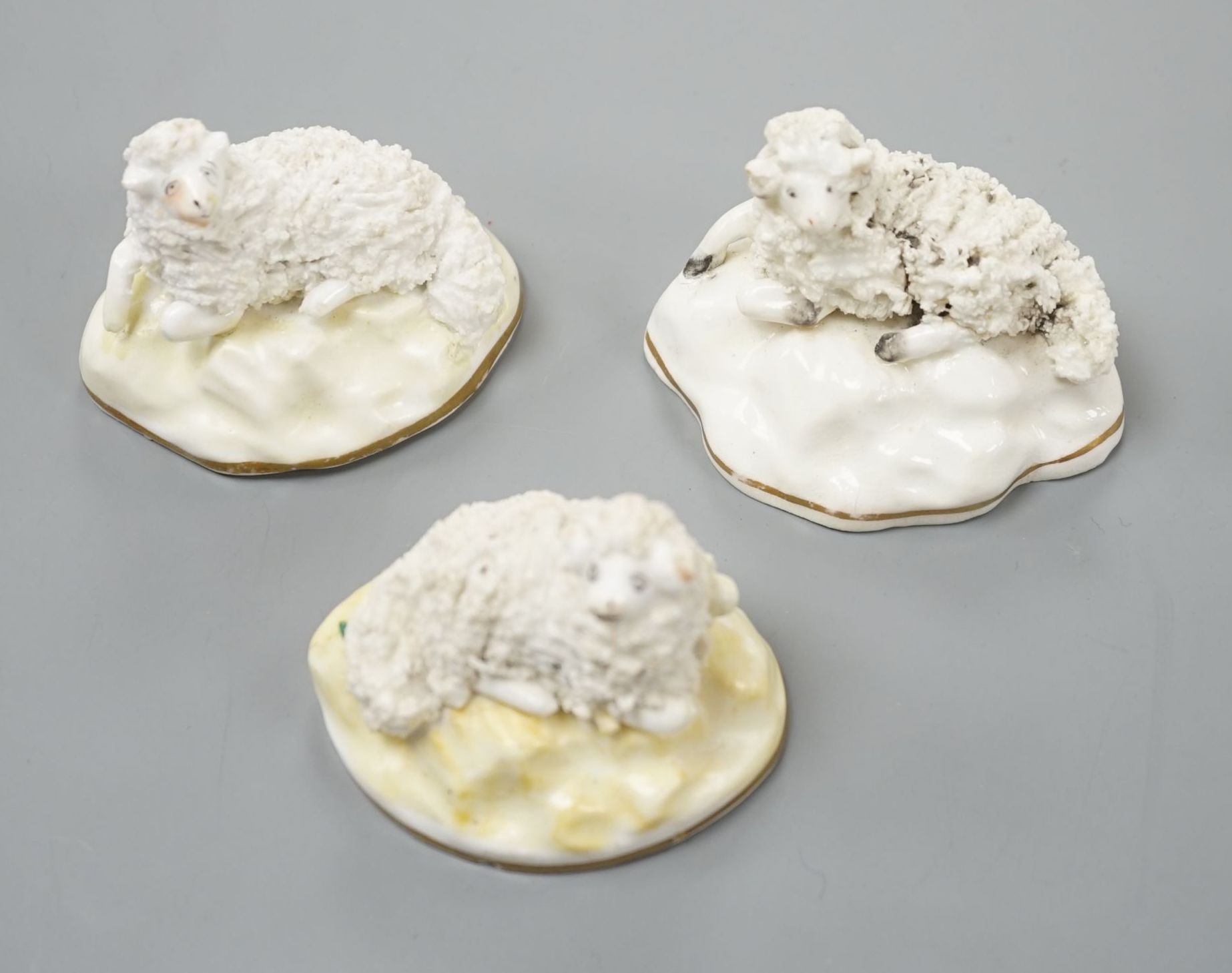 A pair of Samuel Alcock porcelain models of a ram and a ewe, d.1835–50, impressed mark ‘86’, largest 6.6 cm long together with a similar Staffordshire porcelain model of a ram (3), Provenance: Dennis G.Rice collection